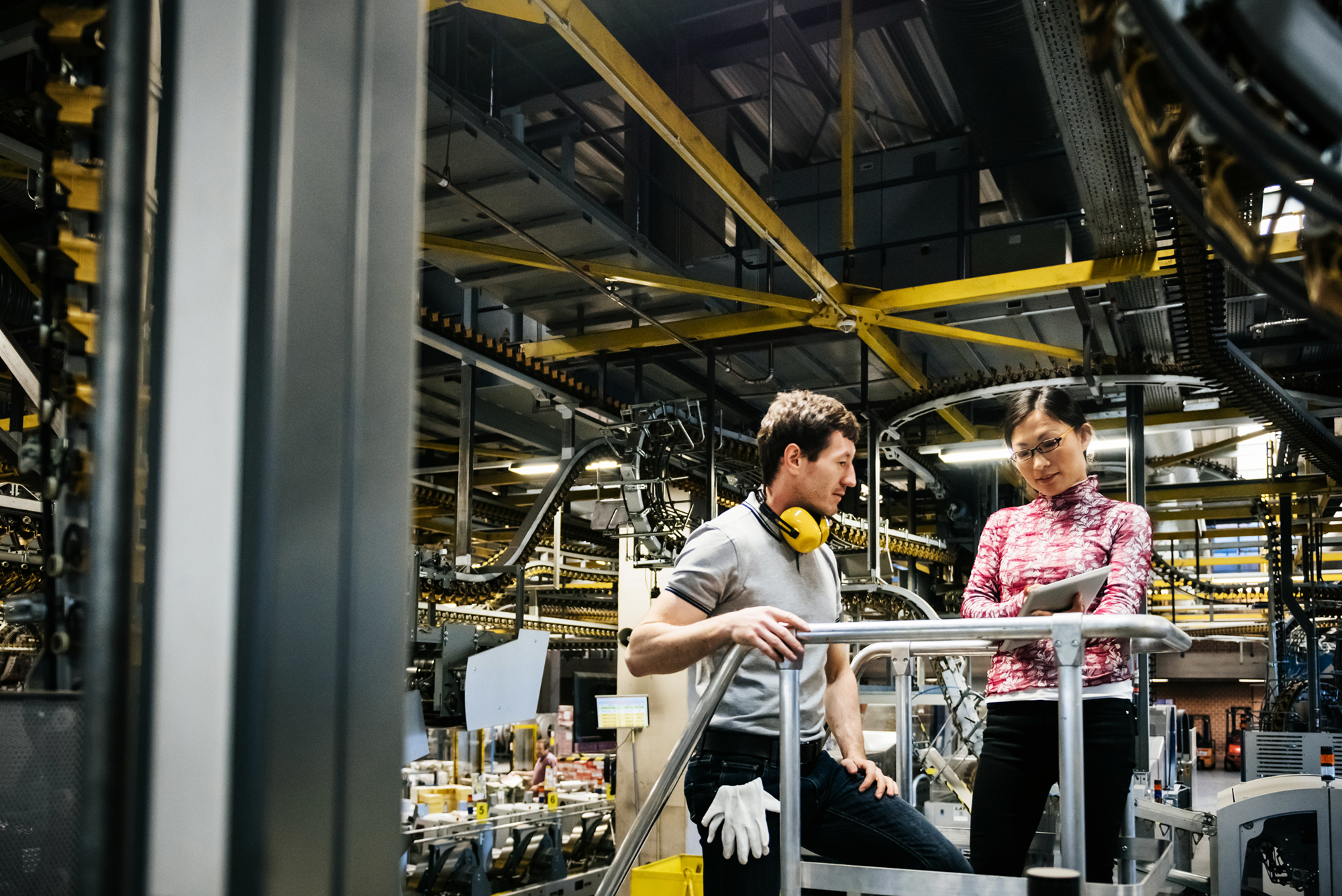 Mechanic and manager talking near a machine