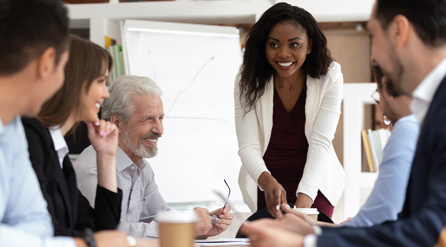 Diverse group of business people with black woman leading discussion