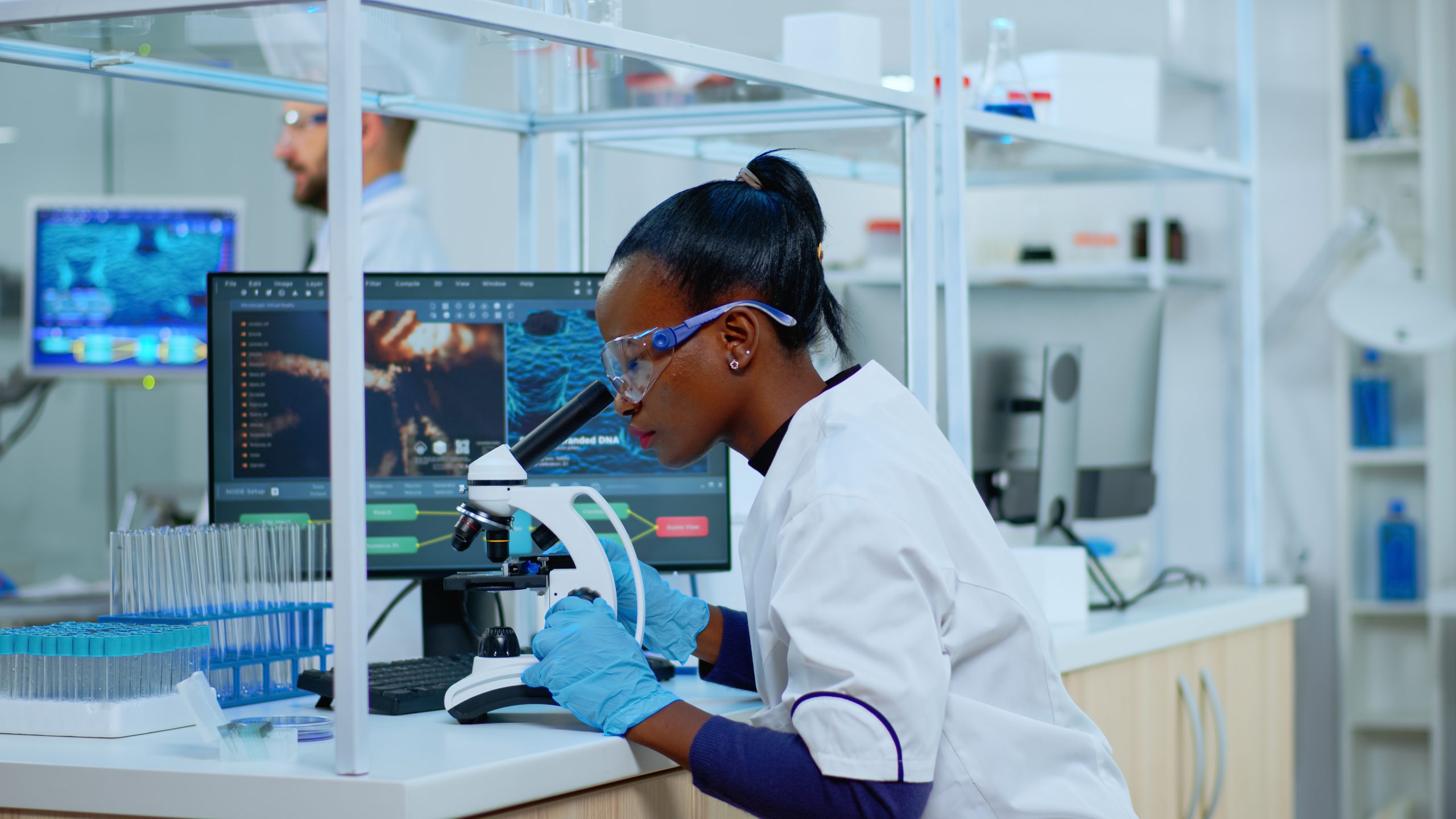 scientist using microscope