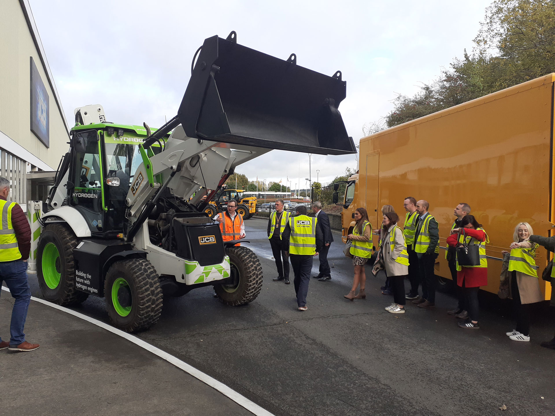 Mid and East Antrim companies and stakeholders from the region’s CleanTech Collaborative Growth Network view a hydrogen-powered digger at the JCB HQ in Rocester