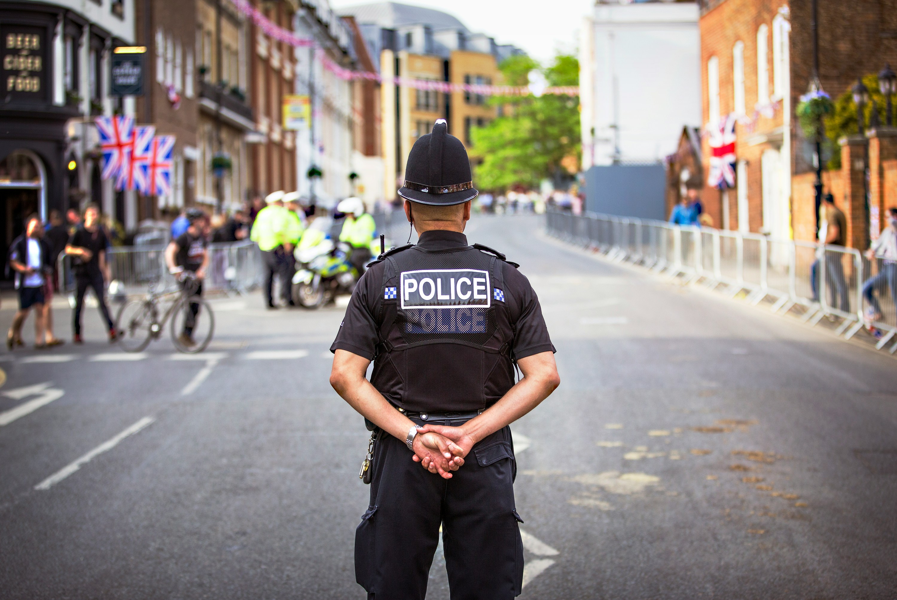 Police officer standing facing away from camera 