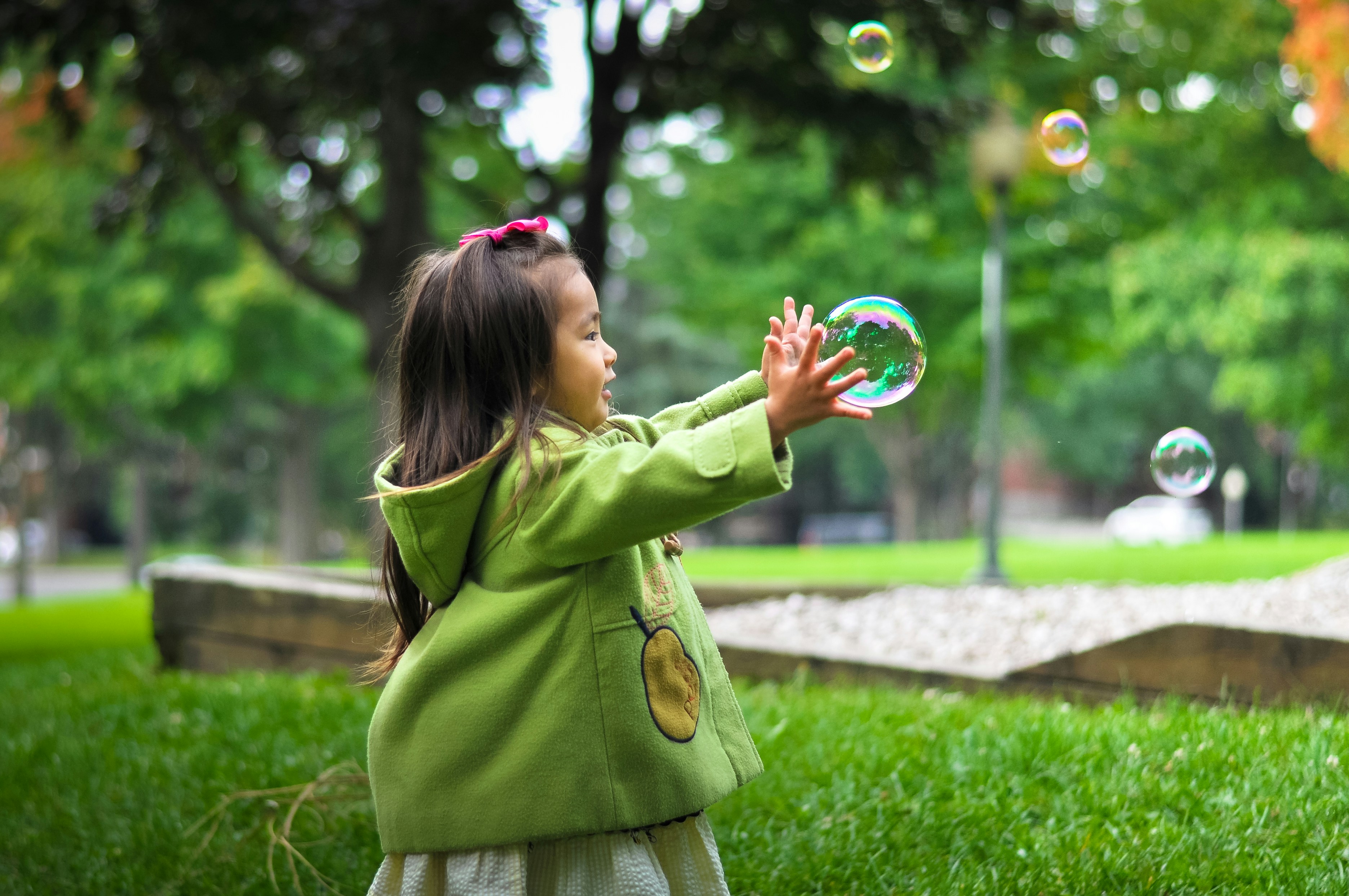chid playing with bubbles